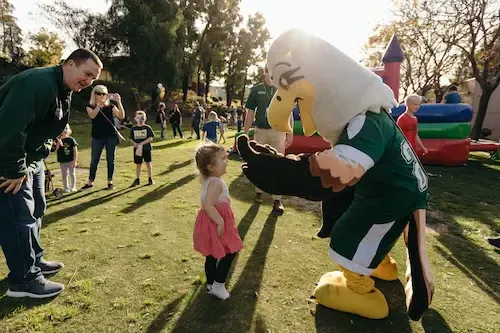 Concordia mascot playing with child